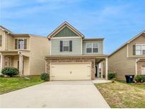 Charming two-story home with a one-car garage and a landscaped yard at 5535 Union Pointe Pl, Union City, GA 30291
