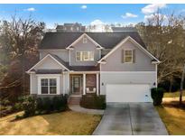 Charming two-story home with a welcoming front porch and attached garage at 264 Creek View Pl, Canton, GA 30114