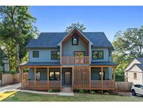 Modern two-story home with blue siding, wood accents, and a covered porch at 561 Ashburton Ave, Decatur, GA 30032