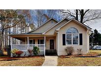 Charming two-story home with a front porch, large windows, and landscaped yard at 1745 Wynfield Ln, Auburn, GA 30011