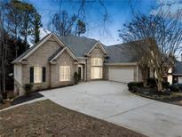 Brick house with a large driveway and mature trees at 1007 Fairway Seven, Villa Rica, GA 30180