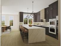 Modern kitchen featuring dark cabinets, large island, and stainless steel appliances at 531 S Main St # 320, Alpharetta, GA 30009