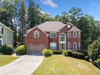 Charming two-story brick home with a two-car garage and landscaped yard at 305 Haley Cir, Atlanta, GA 30349