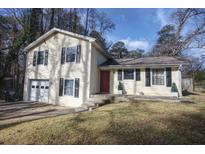 Ranch-style home with attached garage and landscaped yard at 3337 Oak Dr, Snellville, GA 30078