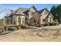 Stately brick home with stone accents, manicured landscaping, and a welcoming front walkway at 2664 River Haven Ct, Lawrenceville, GA 30045