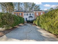 Brick front townhome with a charming bay window and well-manicured landscaping at 1312 Poplar Pointe Se, Smyrna, GA 30082