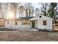 Charming white brick home with a welcoming front porch and landscaping at 681 Farrar Ct, Decatur, GA 30032