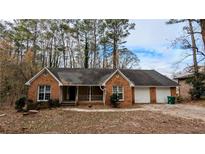 Charming brick ranch home with covered porch and two-car garage at 3419 Wesley Chapel Rd, Decatur, GA 30034