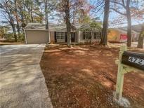 Charming single-story home with a driveway and front yard at 4727 Garden Hills Dr, Stone Mountain, GA 30083