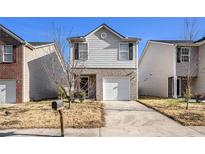Charming two-story home with a one-car garage and a driveway at 2137 Belmont Cir, Conyers, GA 30012
