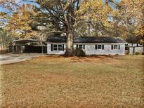 Charming single-story home with a carport and large front yard at 30 N Cleveland Church Rd, Mcdonough, GA 30253