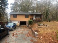 Two-story home with attached garage and driveway at 1213 Anderson Mill Rd, Austell, GA 30106