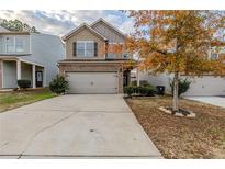 Two-story house with gray siding, two-car garage, and a landscaped yard at 5537 Union Pointe Pl, Union City, GA 30291