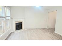 Bright living room features a fireplace and hardwood floors at 1909 Granville Dr, Lawrenceville, GA 30043