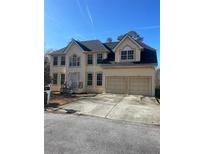 Two-story house with two-car garage and large windows at 1276 Huntington Place Cir, Lithonia, GA 30058