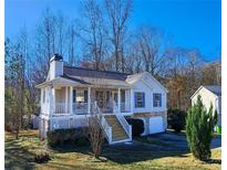 Ranch home with front porch, landscaped yard, and attached garage at 2855 Brass Ct, Austell, GA 30106