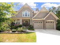 Two-story house with brick and siding, two-car garage, and landscaped yard at 5116 Barton Pass, Acworth, GA 30101