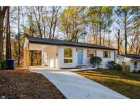 Newly renovated ranch home featuring a light brick exterior, covered porch, and landscaped yard at 474 Fairlock Nw Ln, Atlanta, GA 30331