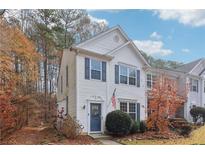 Charming two-story home with blue door and autumn landscaping at 2230 Whitestone Pl, Alpharetta, GA 30005