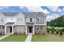 New construction home with brick and siding exterior, front yard, and walkway at 979 Cades Walk, Lawrenceville, GA 30045