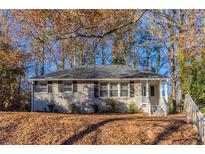 Brick ranch home with mature trees and landscaping at 1807 Oakmont Nw Dr, Atlanta, GA 30314