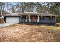 Ranch style home with gray siding, white trim, and a red front door at 155 Meadowbrook Dr, Mcdonough, GA 30253
