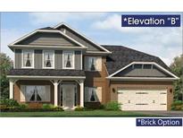 Charming two-story home with a gray and brick exterior, front porch, and attached two-car garage at 5004 Fairview Cir, Villa Rica, GA 30180