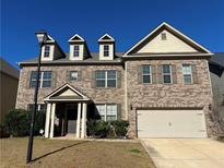 Attractive two-story home with brick and siding exterior, front porch, and attached garage at 566 Mariposa Ln, Mcdonough, GA 30253