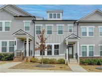 Charming two-story townhome with gray siding, white trim, and a covered entryway at 2689 Richmond Row, Suwanee, GA 30024