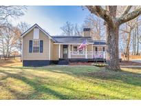 Charming craftsman home with front porch and landscaped yard at 405 Tanner Rd, Dacula, GA 30019