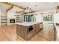 Bright, open kitchen with large island, modern appliances, and wood accents at 6214 Talmadge Nw Way, Acworth, GA 30101