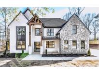 Stunning two-story home features stone and white exterior at 1254 Prospect Rd, Lawrenceville, GA 30043