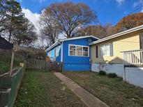 Charming blue home with a fenced yard and walkway at 149 Bixby Se Ter, Atlanta, GA 30317