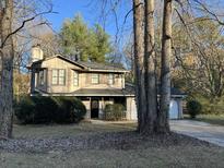 Charming two-story home nestled among trees with a welcoming front porch at 1654 Tree Line Rd, Lithonia, GA 30058