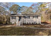 Brick ranch house with a landscaped lawn and walkway at 4731 Kings Hwy, Douglasville, GA 30135