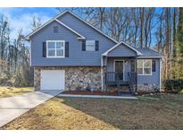 Newly renovated blue house with stone accents and a large yard at 100 Spicewood Ct, South Fulton, GA 30349