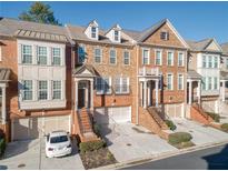 Brick townhouses with attached garages and landscaped yards at 5012 Ridgemont Se Walk # 19, Atlanta, GA 30339