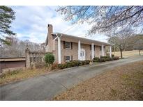 Brick ranch house with long driveway, landscaping, and detached garage at 2192 Weslan Dr, Austell, GA 30106