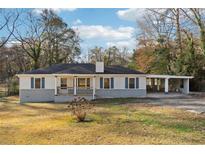 Newly renovated ranch home with a carport and landscaped yard at 1751 Nathan Ln, Austell, GA 30168
