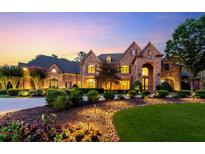 Elegant stone house with manicured landscaping and a charming driveway at 6206 Zell Miller Nw Path, Acworth, GA 30101