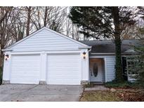 Three-car garage, white exterior, landscaping at 2688 Crystal Ln, Lawrenceville, GA 30044
