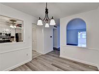 Bright dining room features an archway, new flooring, and view into kitchen at 123 Maison Nw, Atlanta, GA 30327