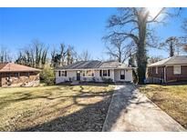 Charming ranch home with a long driveway and spacious yard at 1620 Flintwood Se Dr, Atlanta, GA 30316