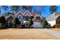 Two-story house with stone accents and manicured lawn at 195 Brookhollow Trce, Johns Creek, GA 30022