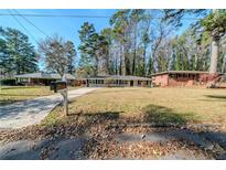 Ranch style home with a spacious yard and driveway at 1471 Midview Dr, Decatur, GA 30032