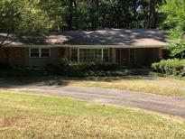 Brick ranch house with a large yard and driveway at 138 Le Brun Ne Rd, Atlanta, GA 30342