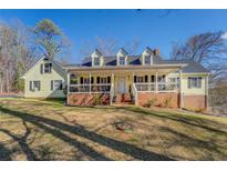 Ranch style home with large porch and landscaped yard at 1060 River Cove Rd, Social Circle, GA 30025