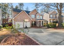 Brick two-story house with a two-car garage and a basketball hoop at 250 Windsor Way, Fairburn, GA 30213