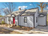 Charming gray house with red door, landscaping, and a spacious deck at 1591 Athens Sw Ave, Atlanta, GA 30310