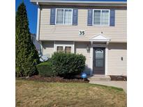 Two-story townhome with neutral siding, landscaping, and a black front door at 1625 Conley Rd # 229, Conley, GA 30288